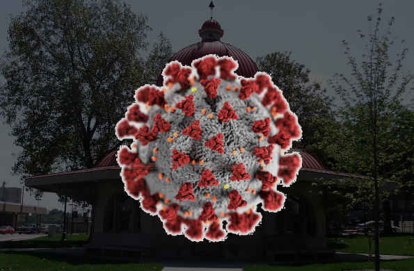 A stock photo of covid 19 virus with a slightly transparent background, covering up the Decatur Transfer House in Central Park.